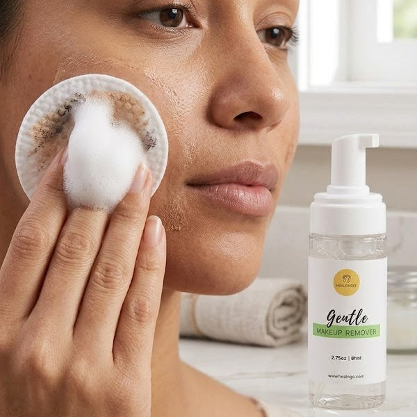 Woman applying a facial product with a cotton pad, next to a bottle of Gentle Skincare Solution.