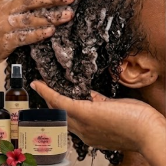 Person washing hair with hibiscus cowash which is a natural hair care products